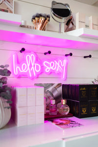 "hello sexy" sign and both perfume options on display: Wildish + Kittenish 2.0