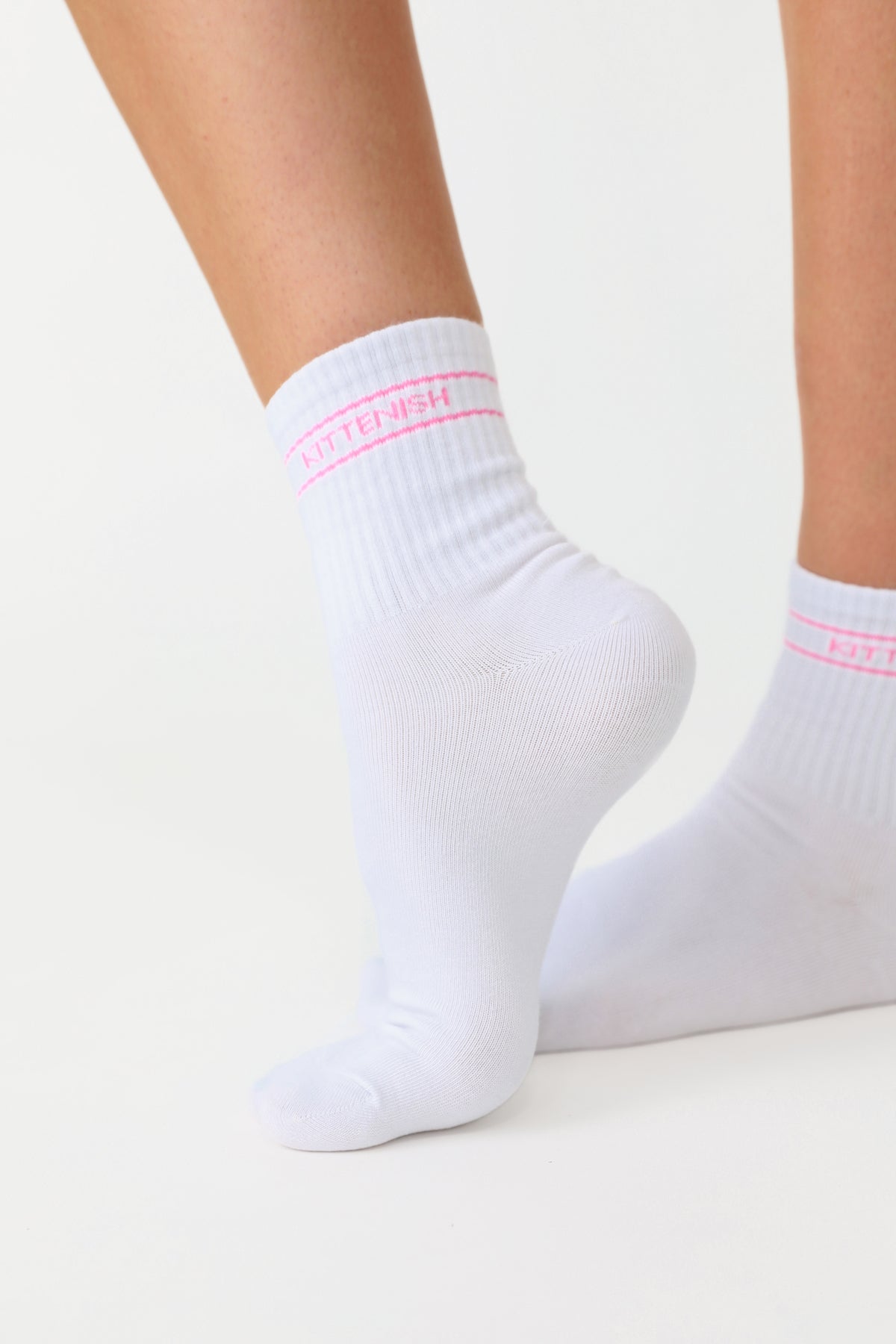 Model wearing pink logo Kittenish socks.