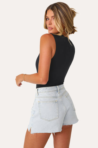 Model wearing the Black Signature Sleeveless Bodysuit. 