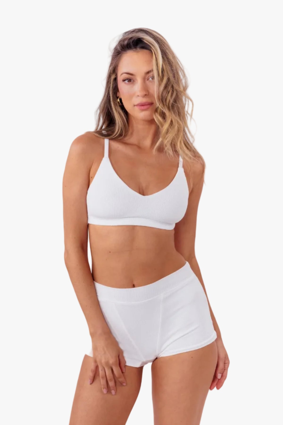 model wearing white ribbed boyshort with matching bralette standing in front of a white backdrop