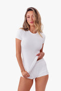 Model wearing a white short-sleeve ribbed top and matching white shorts against a plain white studio background.