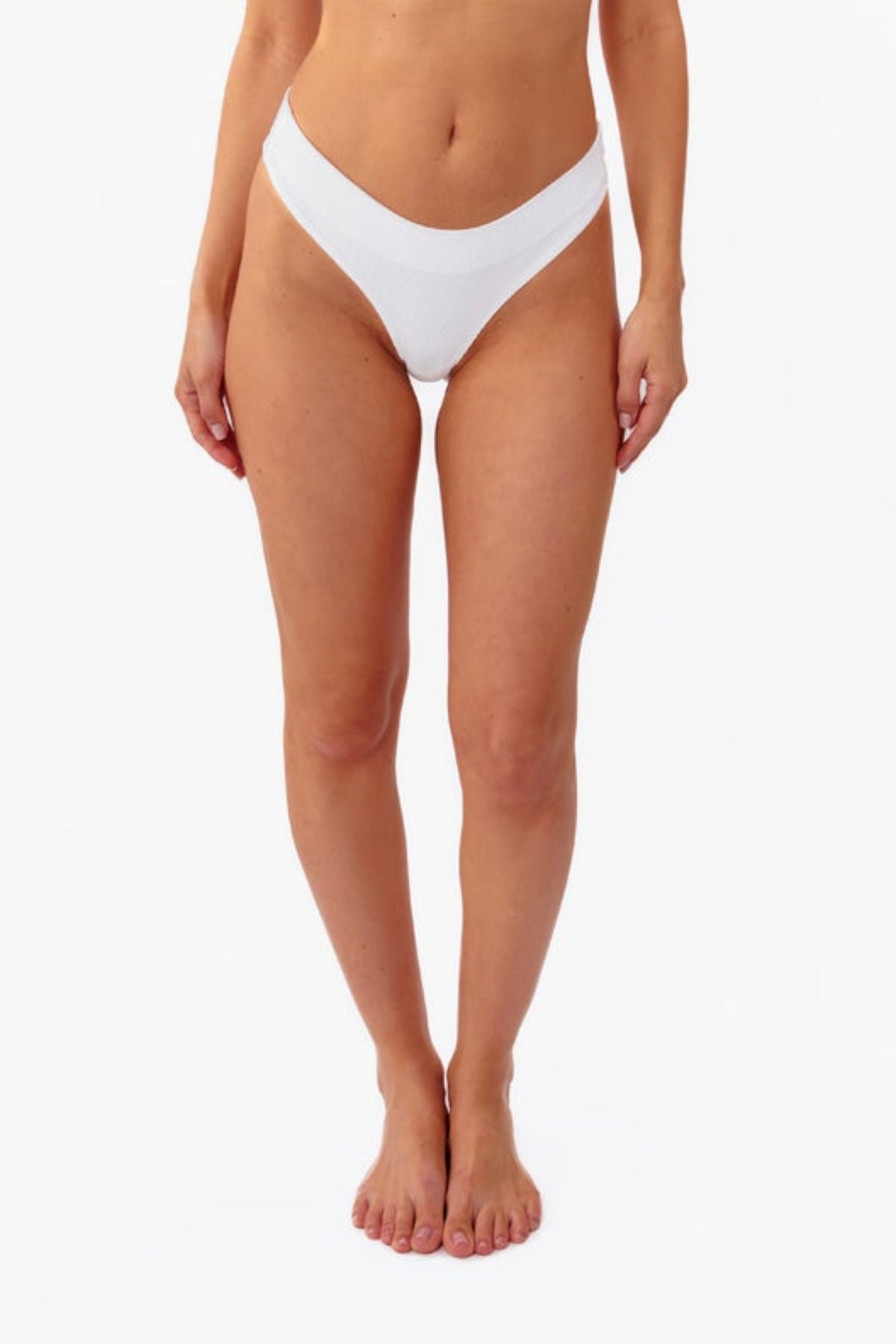 A model wearing a white ribbed thong, shown from the waist down against a plain white background.
