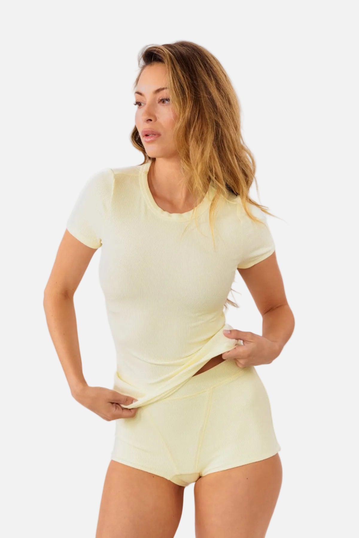 A model wearing pale yellow high-waisted ribbed boyshorts and matching tee