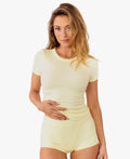 Model wearing a pale yellow short-sleeve shirt with matching shorts against a plain white background.