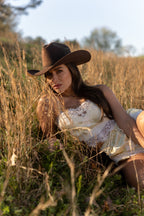 Woman wearing a cowboy hat in a field