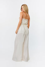 Woman wearing a white jumpsuit on a white background