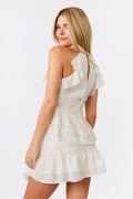 Woman wearing a white halter tank with ruffles and a tiered skirt on a white background