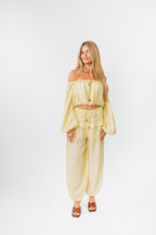 Woman wearing a yellow outfit on a white background