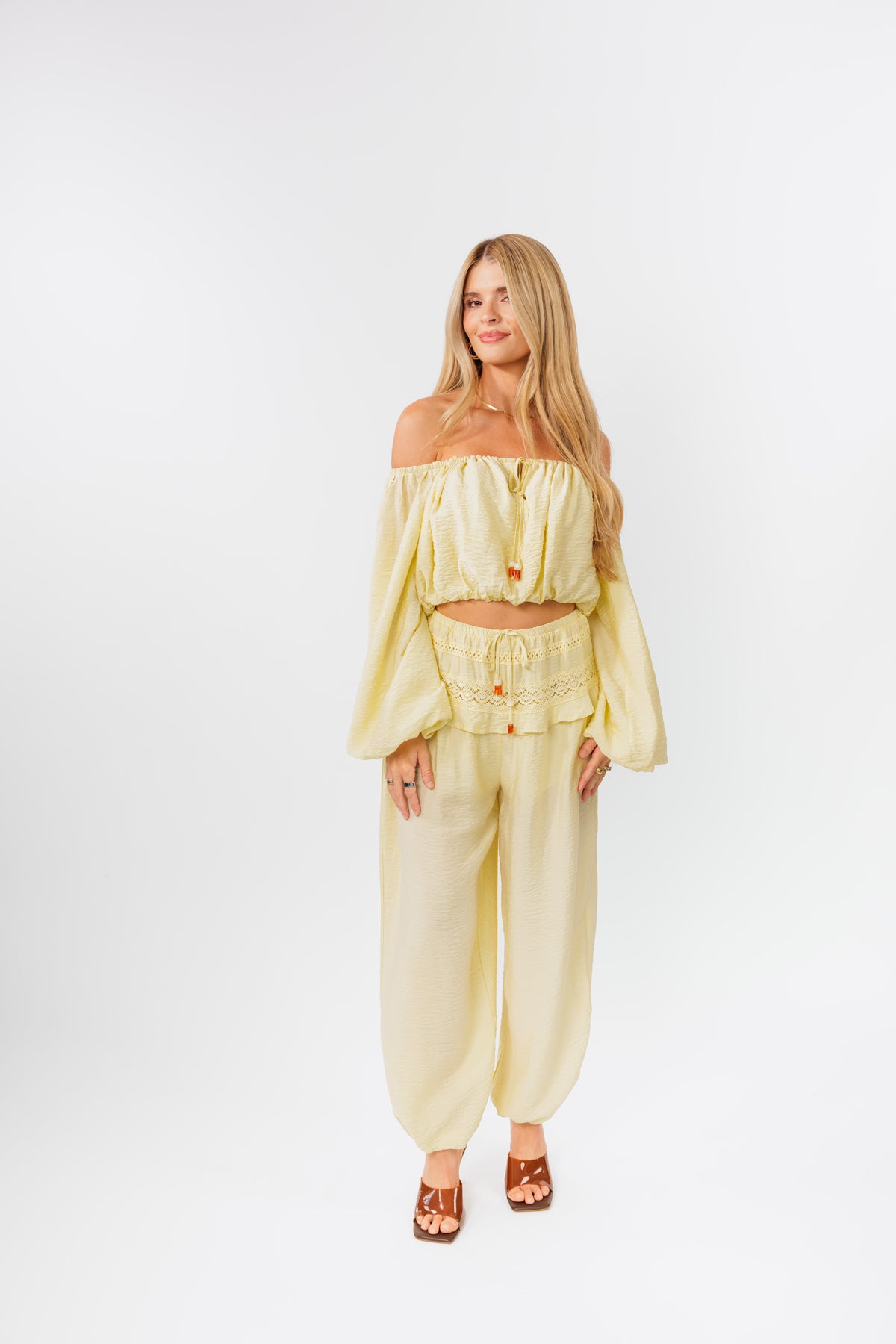 Woman wearing a yellow outfit on a white background