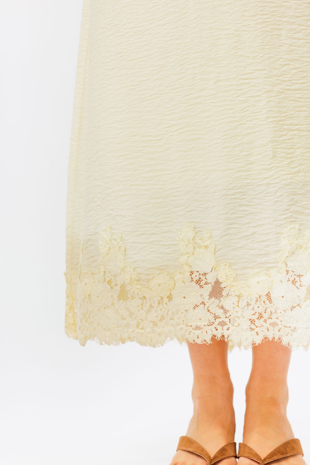 Cream-colored lace dress with a plain background