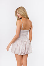 Woman wearing a striped dress on a white background