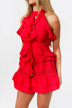 Red ruffled set worn by a model on a white background