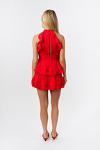 Woman wearing a red set on a white background
