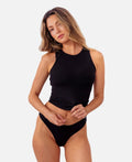 model wearing black ribbed tank with matching thong