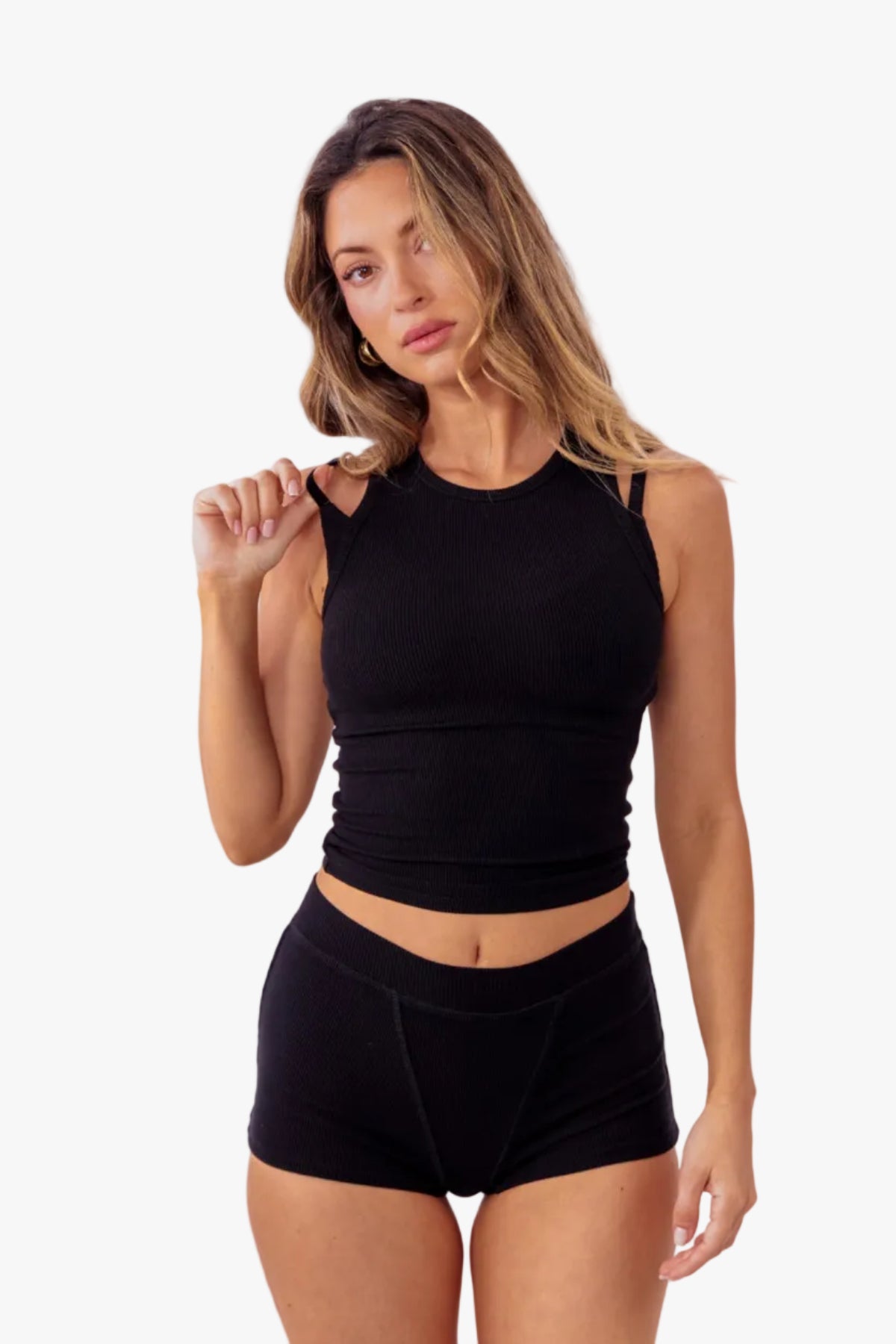 A model wearing black ribbed boyshorts and a matching tank against a plain white background.