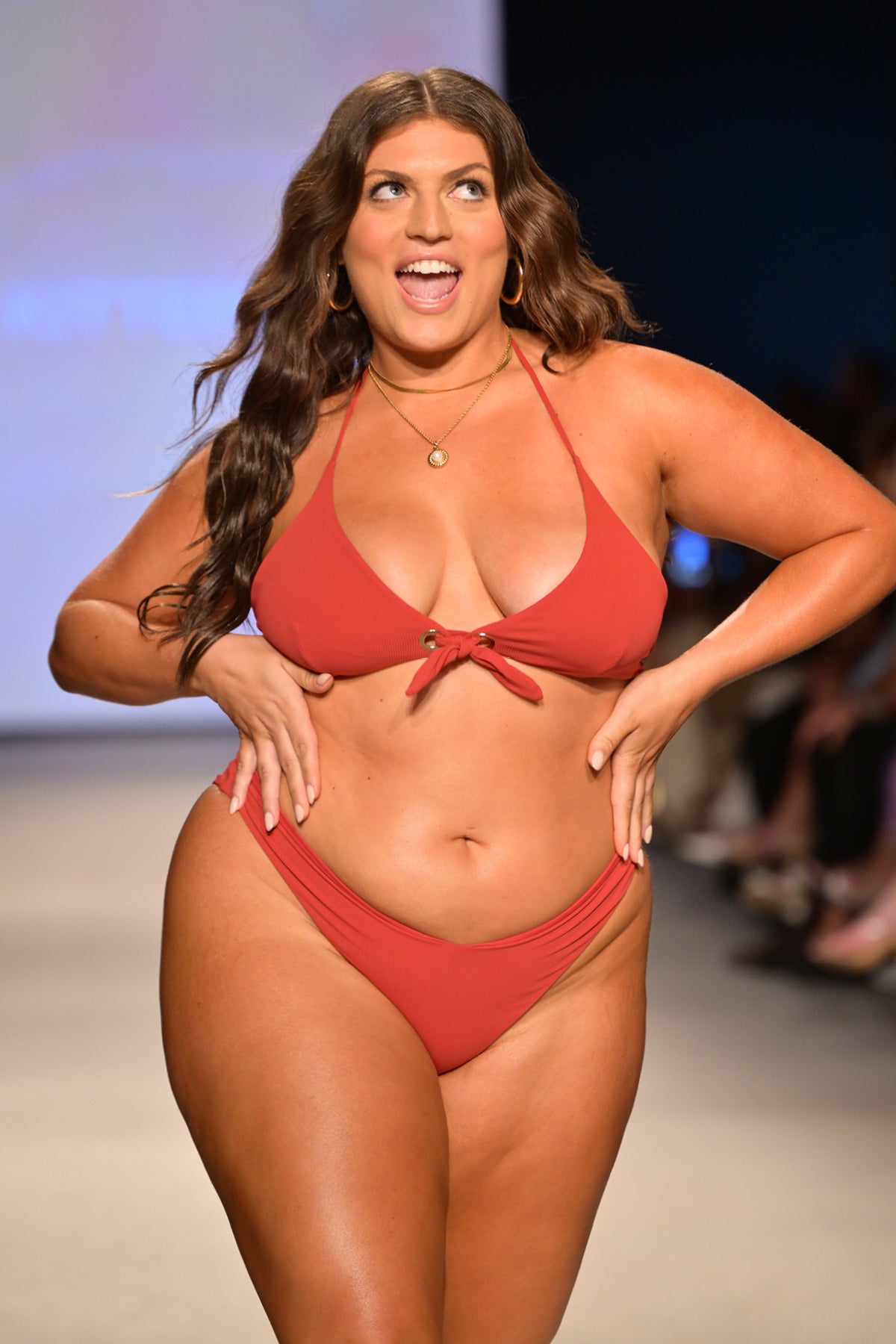 Model Gabriella Halikas wearing the Martina red triangle bikini top on the runway at Miami Swim Week