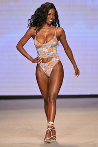 Model Justine Ndiba wearing the Maria cutout one piece on the runway at Miami Swim Week