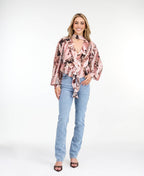 Model wearing high waisted skinny straight leg jeans with a studded waistband paired with kitten heels.