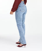 Model wearing high waisted skinny straight leg jeans with a studded waistband paired with kitten heels.