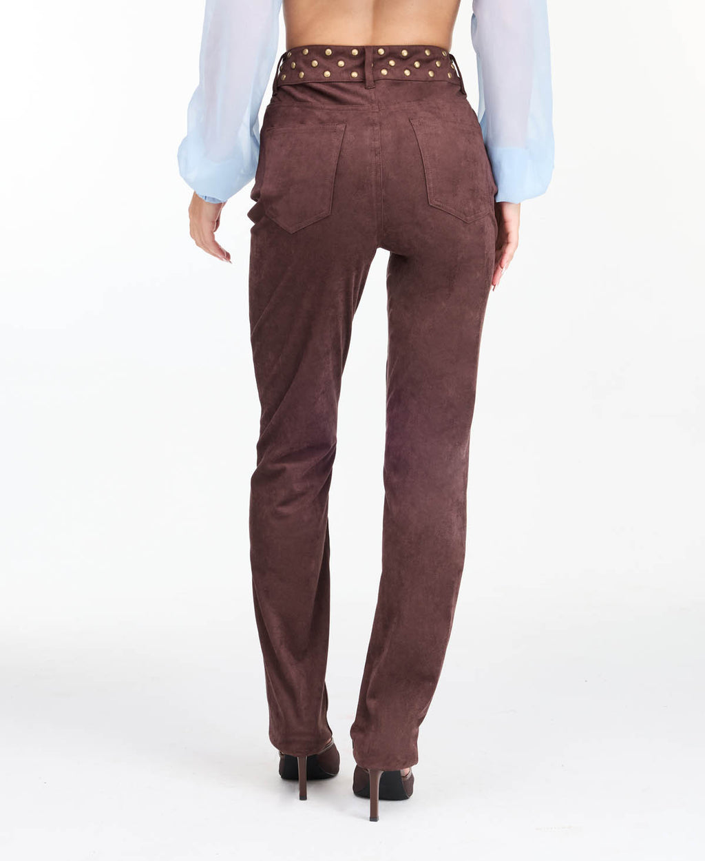 model wearing brown high waisted skinny straight leg pants with brown kitten heels.