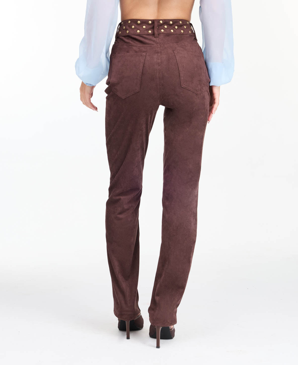model wearing brown high waisted skinny straight leg pants with brown kitten heels.