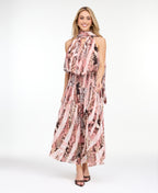 Model wearing a pink snake print midi dress with a smocked waistband and neck scarf standing against a white backdrop