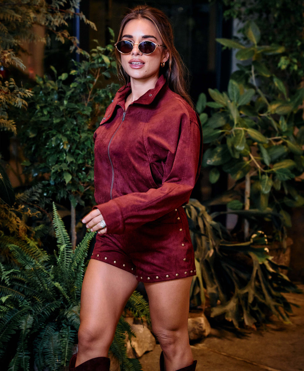 Jessie wearing wine bomber jacket with matching wine hot shorts.