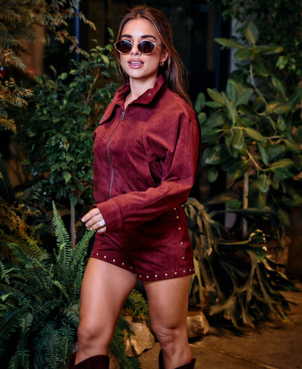 Jessie wearing wine bomber jacket with matching wine hot shorts.