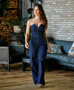 Jessie wearing dark wash denim jumpsuit with heels