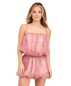 A model is shown from the waist down wearing a pink and red floral print bubble short paired with dark burgundy suede knee-high boots, against a plain white studio background.