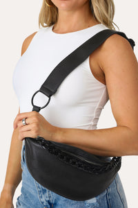 MODEL POSES WITH BLACK CHAIN LINK FANNY PACK
