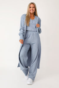 Model wearing the Self Care blue lounge cardigan.