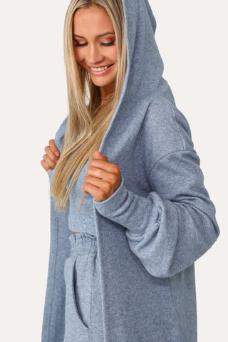 Model wearing the Self Care blue lounge cardigan.