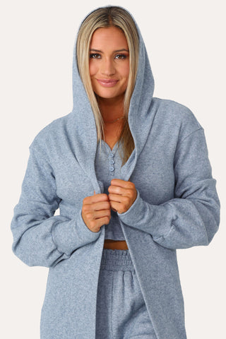Model wearing the Self Care blue lounge cardigan.