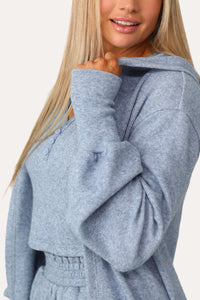 Model wearing the Self Care blue lounge cardigan.