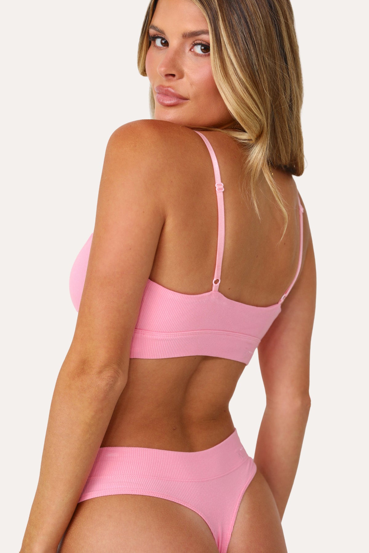Model wearing the Bubble Gum Pink basics Bralette