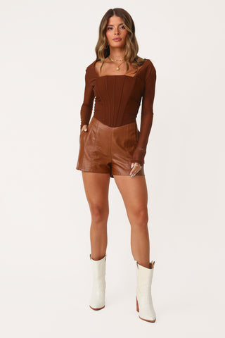 Model wearing Chestnut Vegan Leather Shorts.