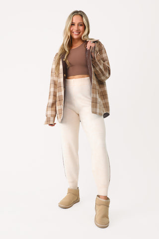Model wearing Cream Fuzzy Joggers.