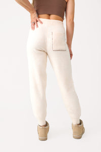 Model wearing Cream Fuzzy Joggers.