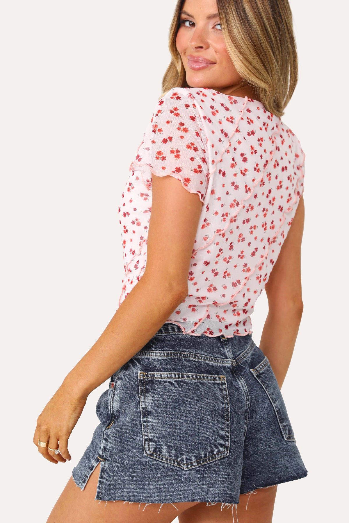 Model wearing the Freedom Floral baby tee.