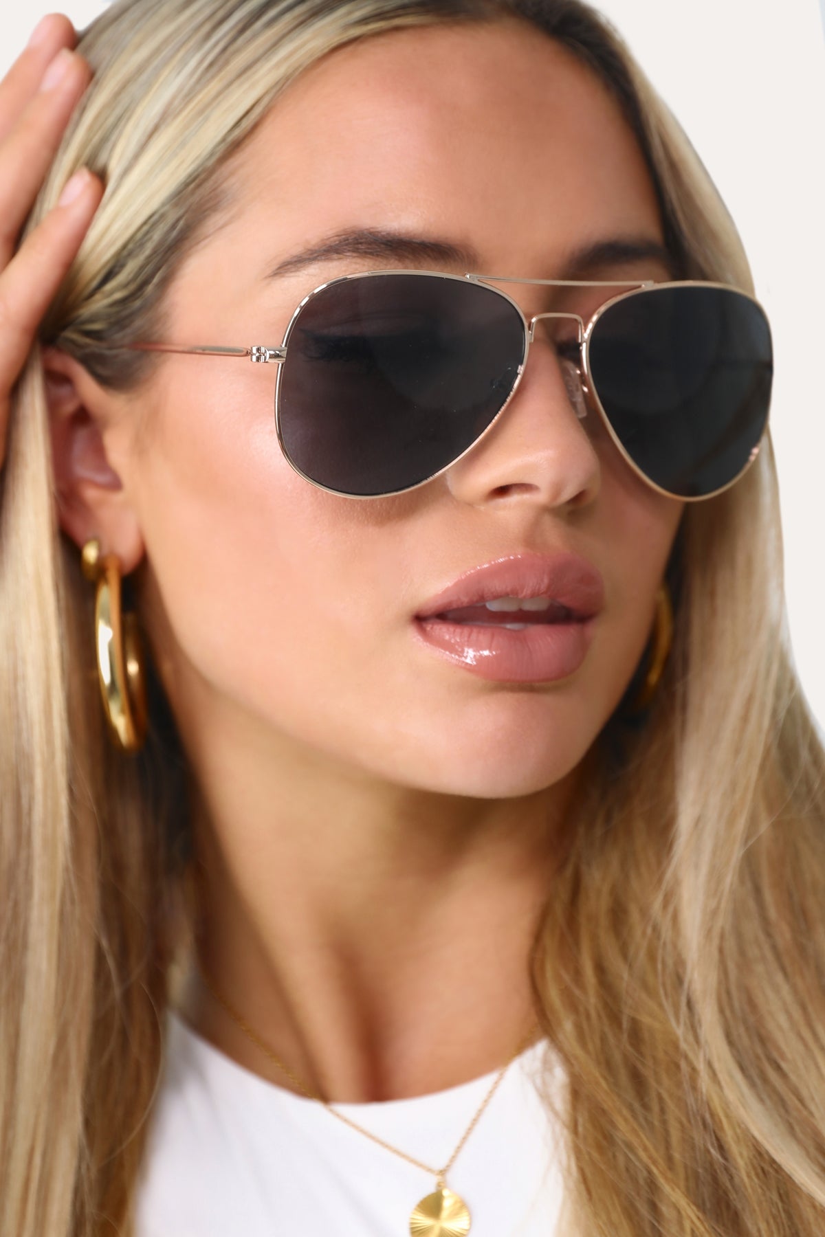 Model wearing The Sydney classic gold aviator sunglasses.