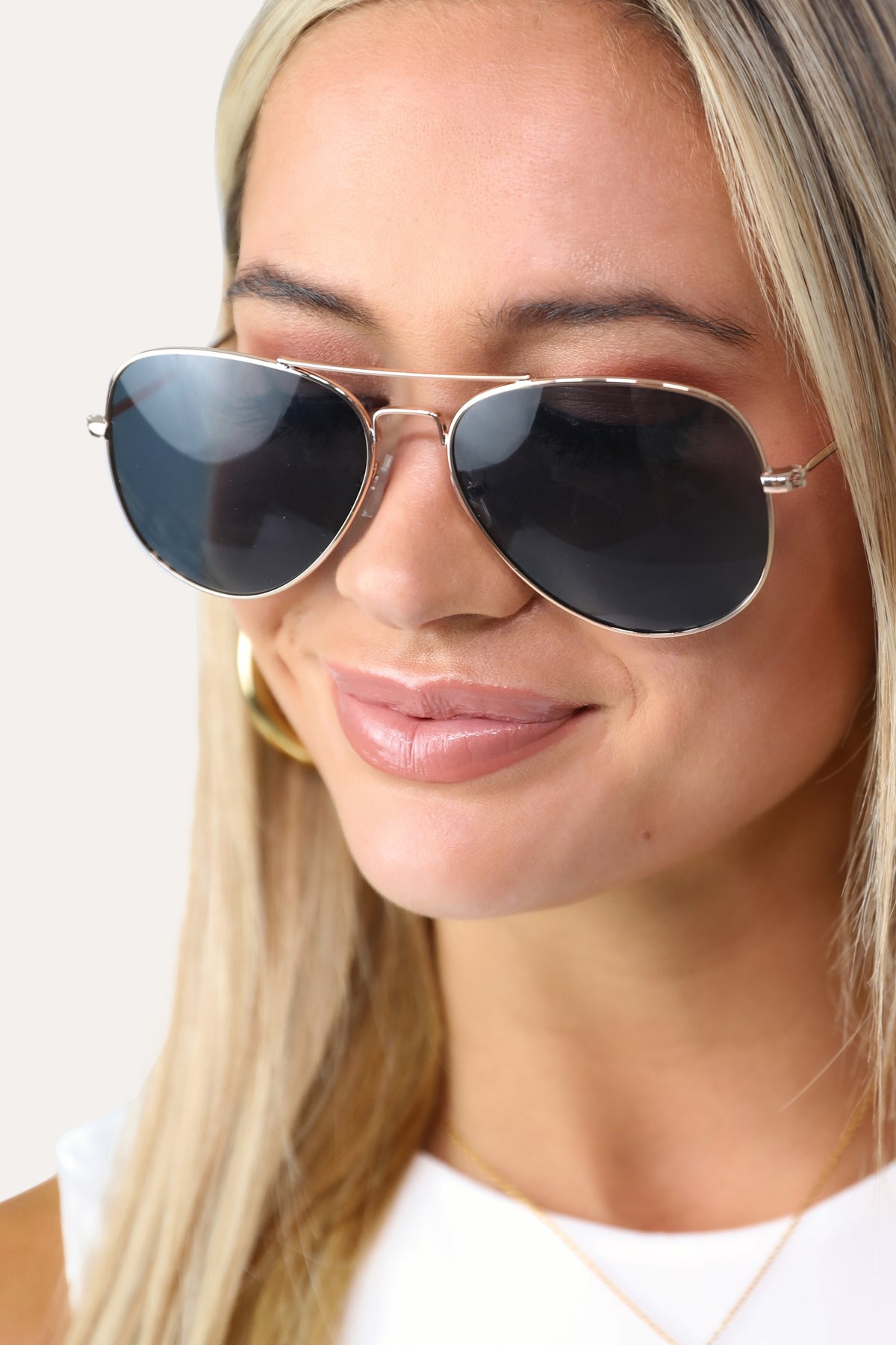 Model wearing The Sydney classic gold aviator sunglasses.