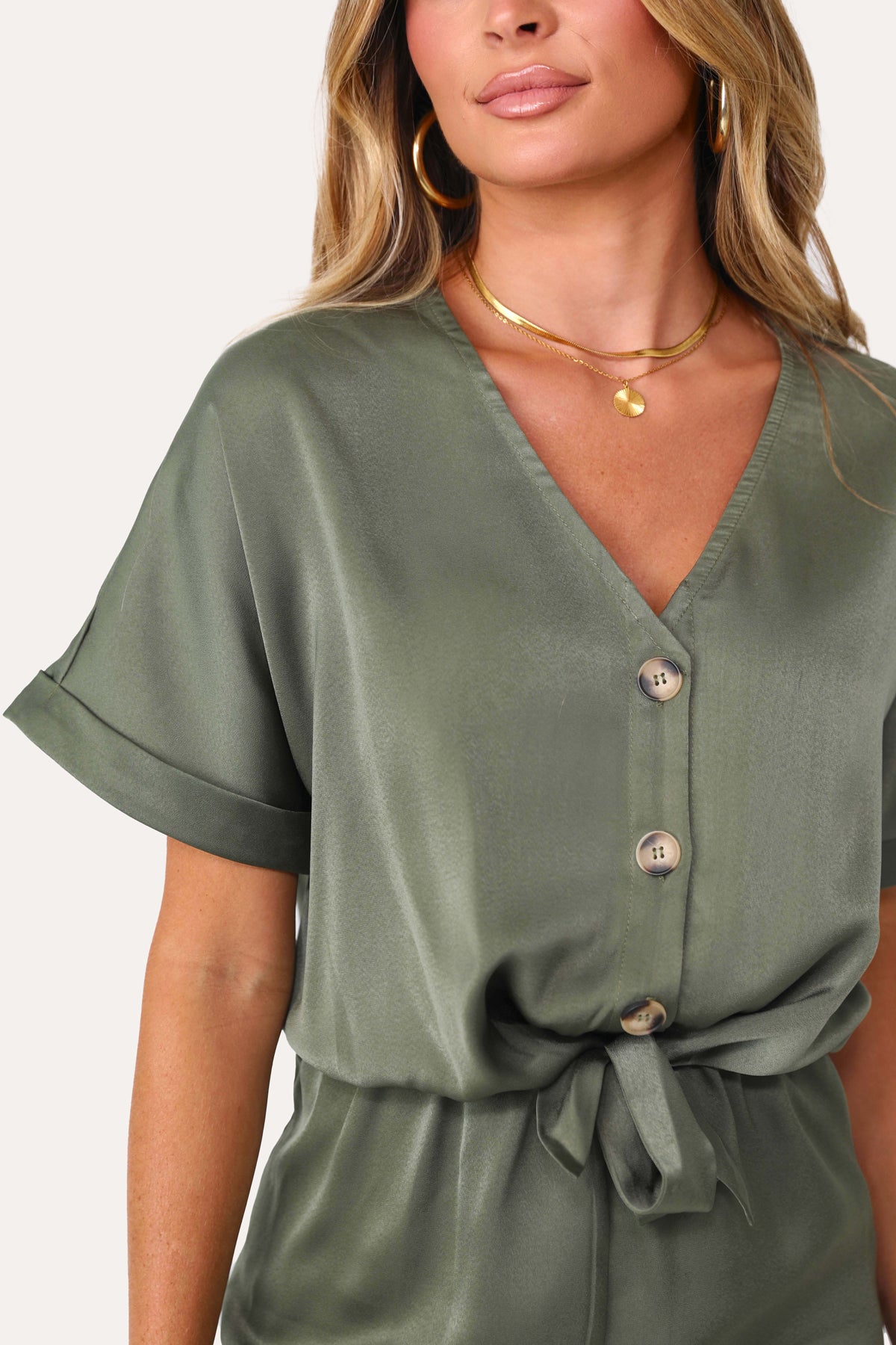 Model wearing the Under The Palms Deep Green Romper.