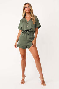 Model wearing the Under The Palms Deep Green Romper.