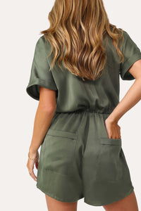 Model wearing the Under The Palms Deep Green Romper.