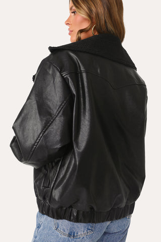 MODEL WEARING THE ON MY WAY BLACK FAUX LEATHER JACKET