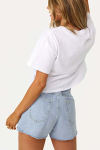 Model wearing Loni Light Denim Belted Shorts.