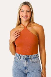 Model wearing the Mimosa Orange Halter Bodysuit.