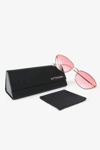 Model wearing The Vivianne pink cat eye sunglasses, kittenish case and wipe cloth. 