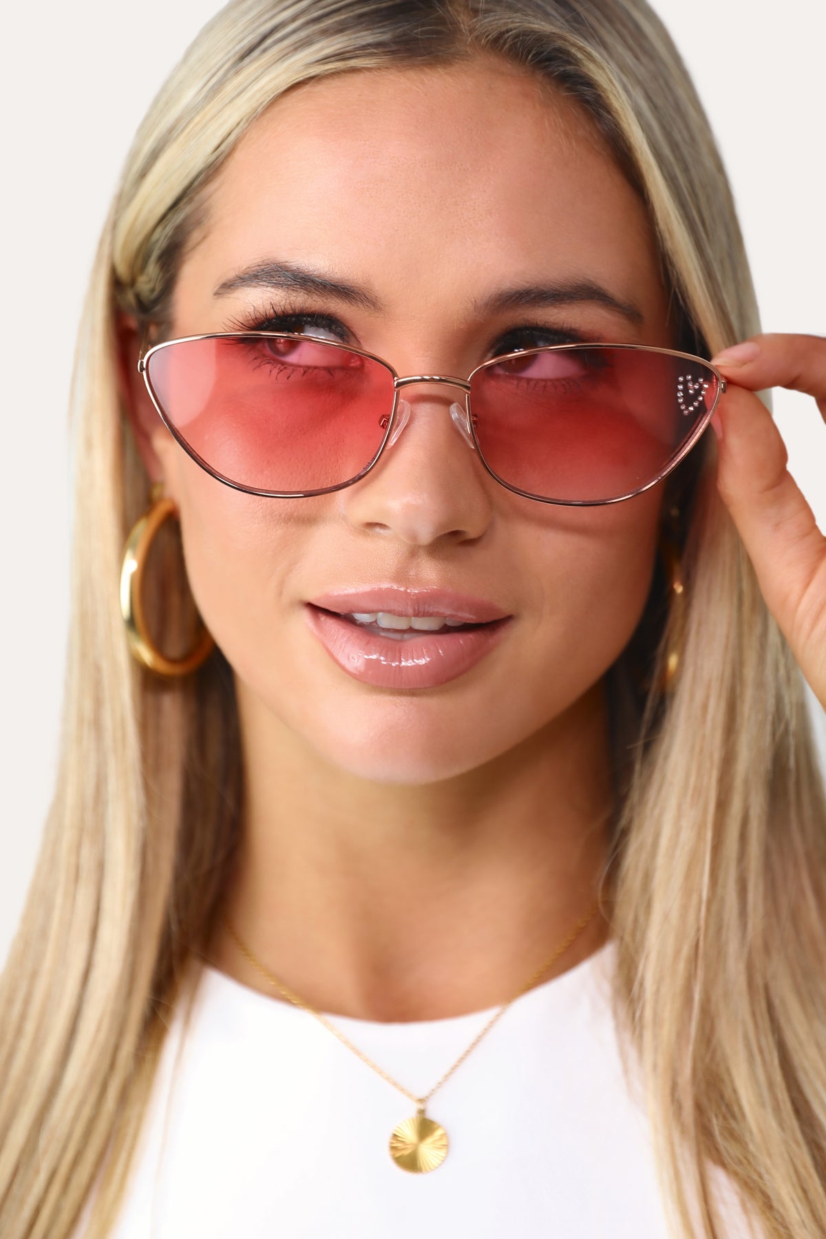 Model wearing The Vivianne pink cat eye sunglasses.